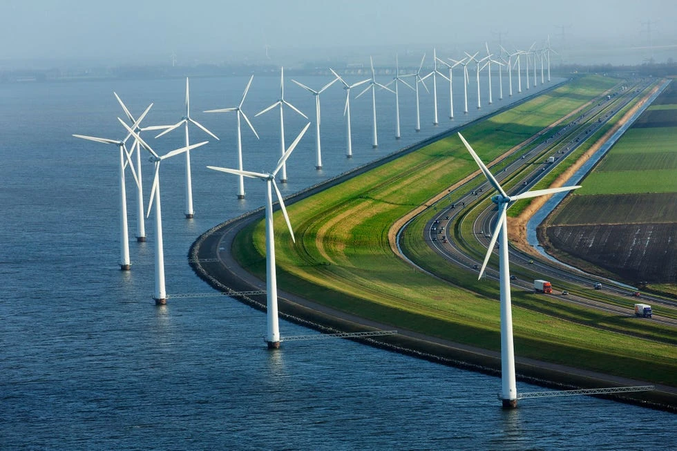 Dutch windmills along a canal at sunset